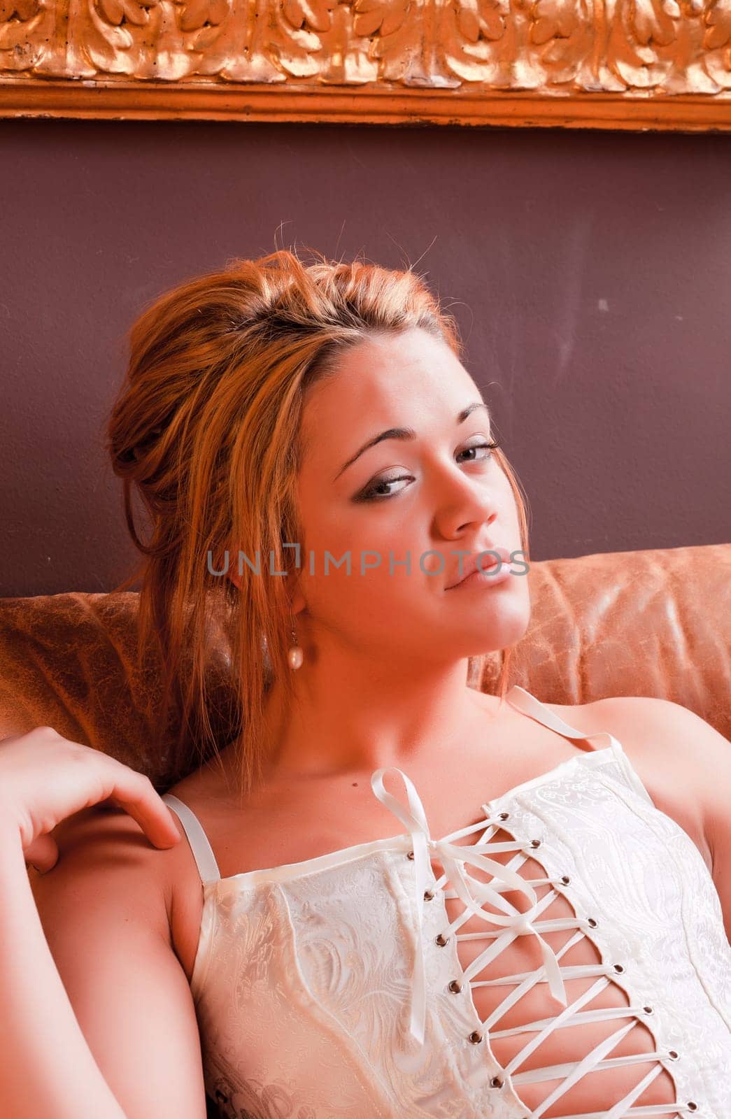 Sensual blonde girl in underwear on armchair