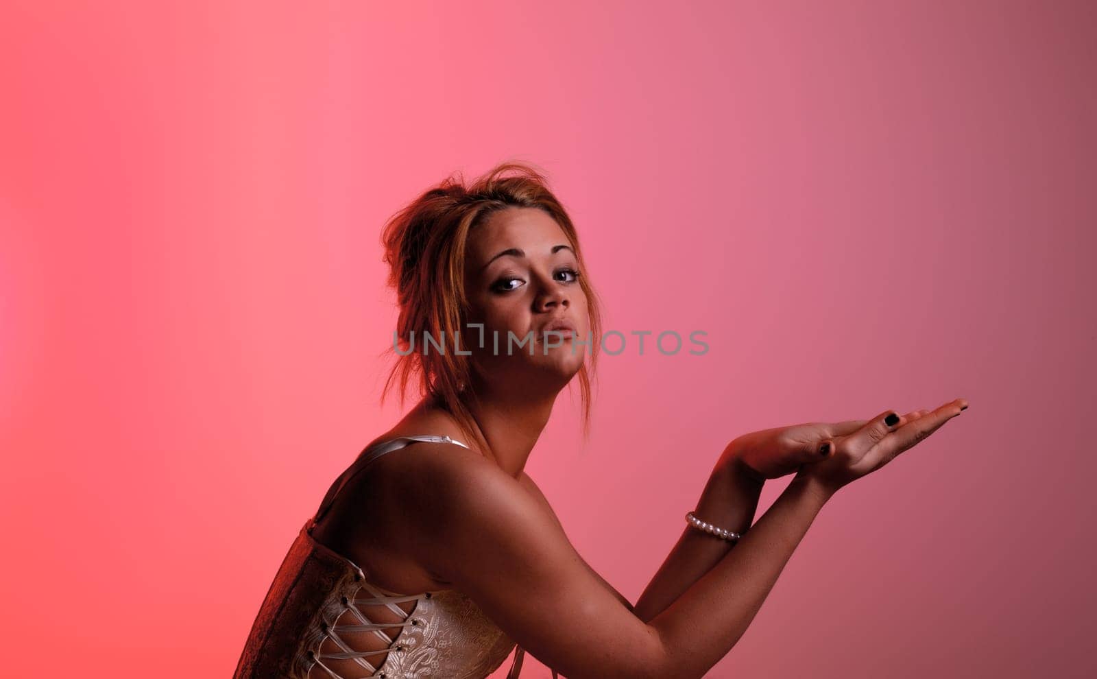 Sensual blonde girl on pink background
