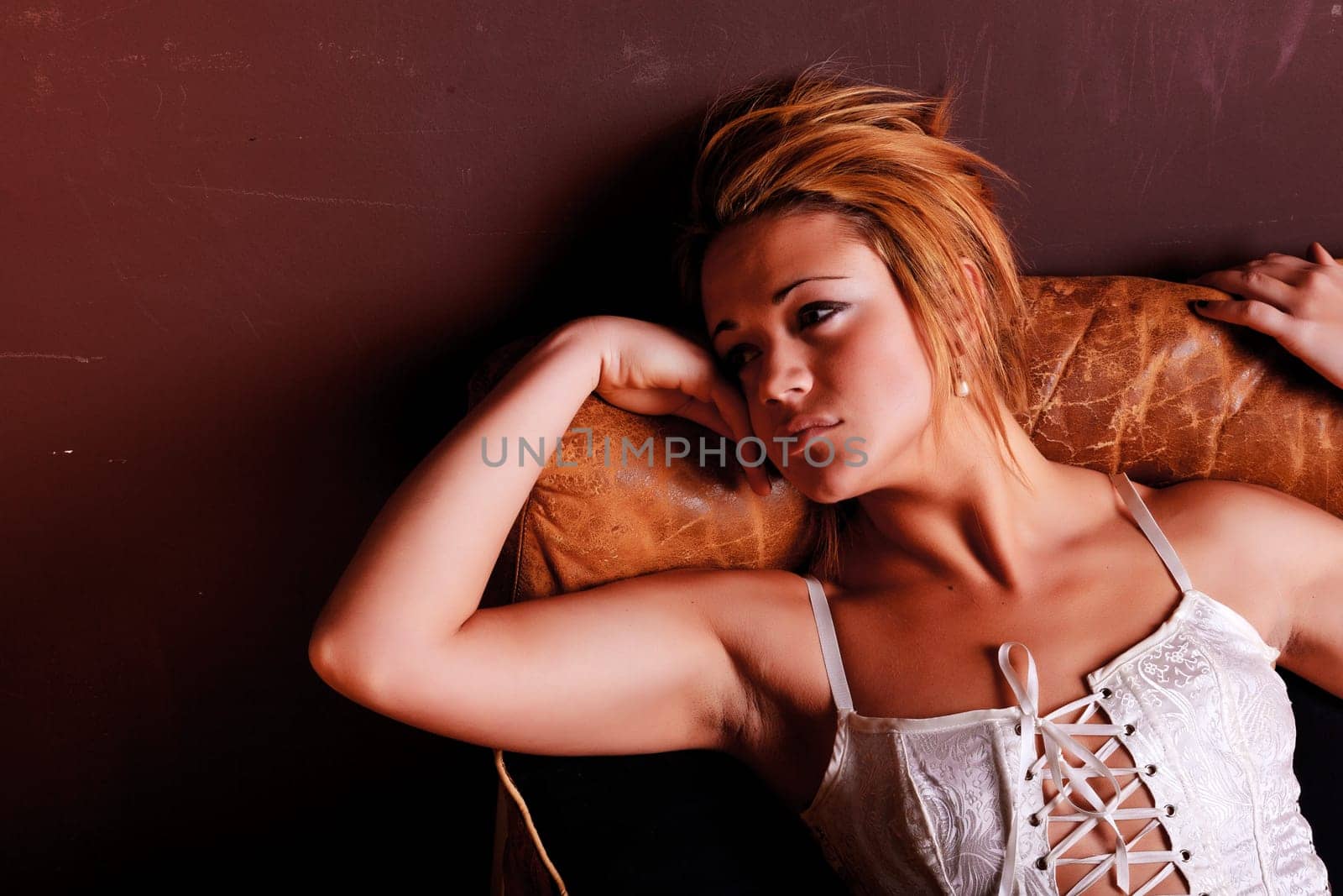 Sensual blonde girl in underwear on armchair