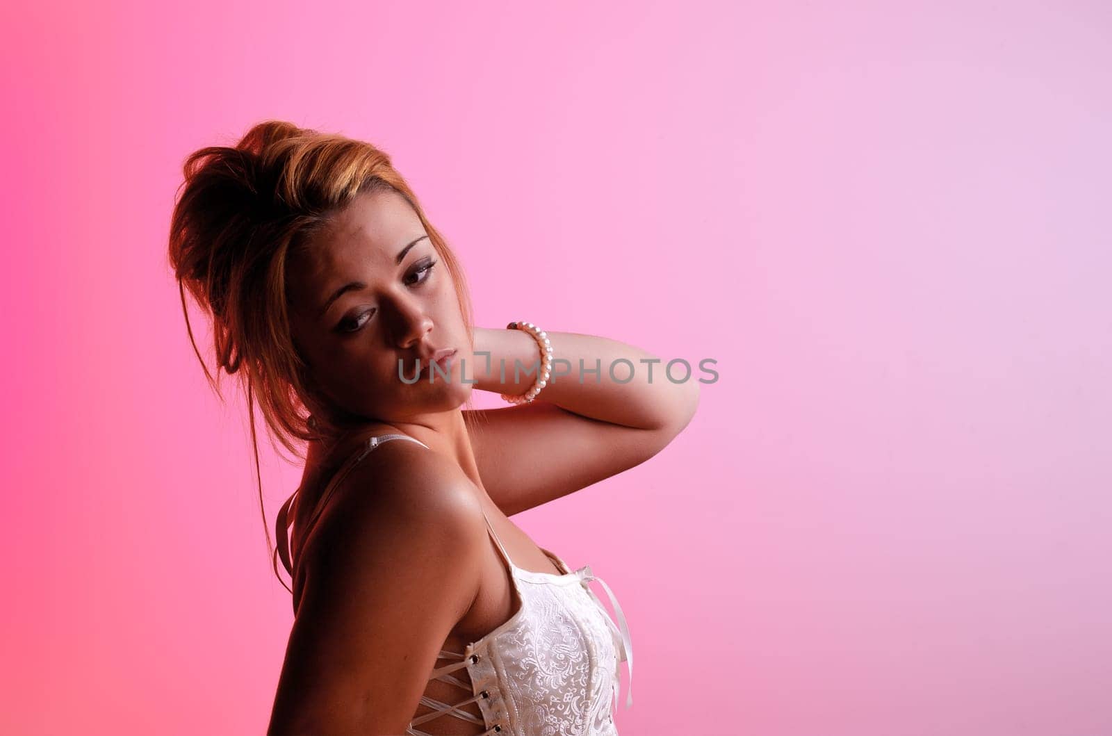 Sensual blonde girl on pink background