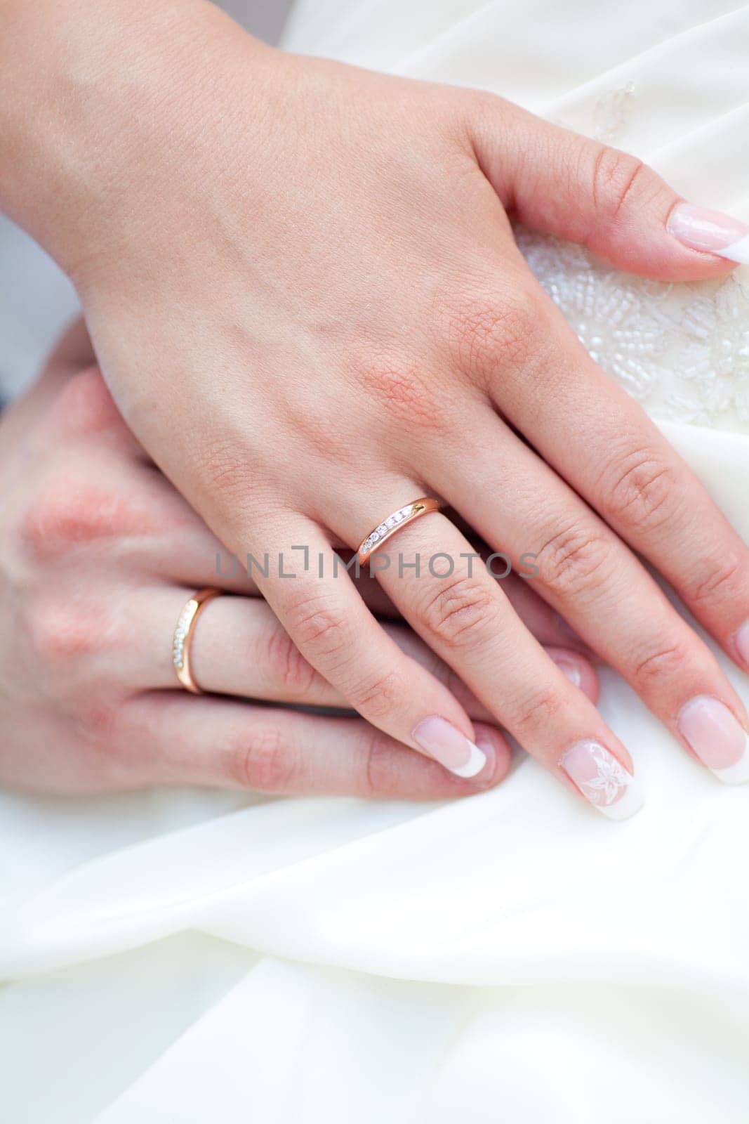 The bride and groom's hands together