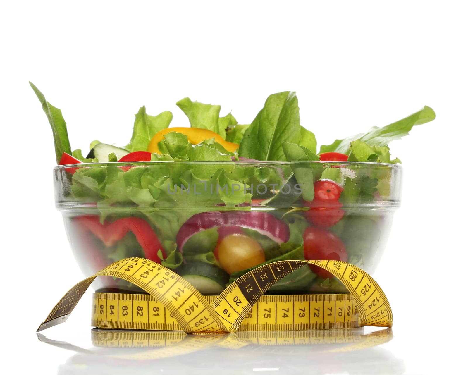 Healthy salad and a measuring tape isolated
