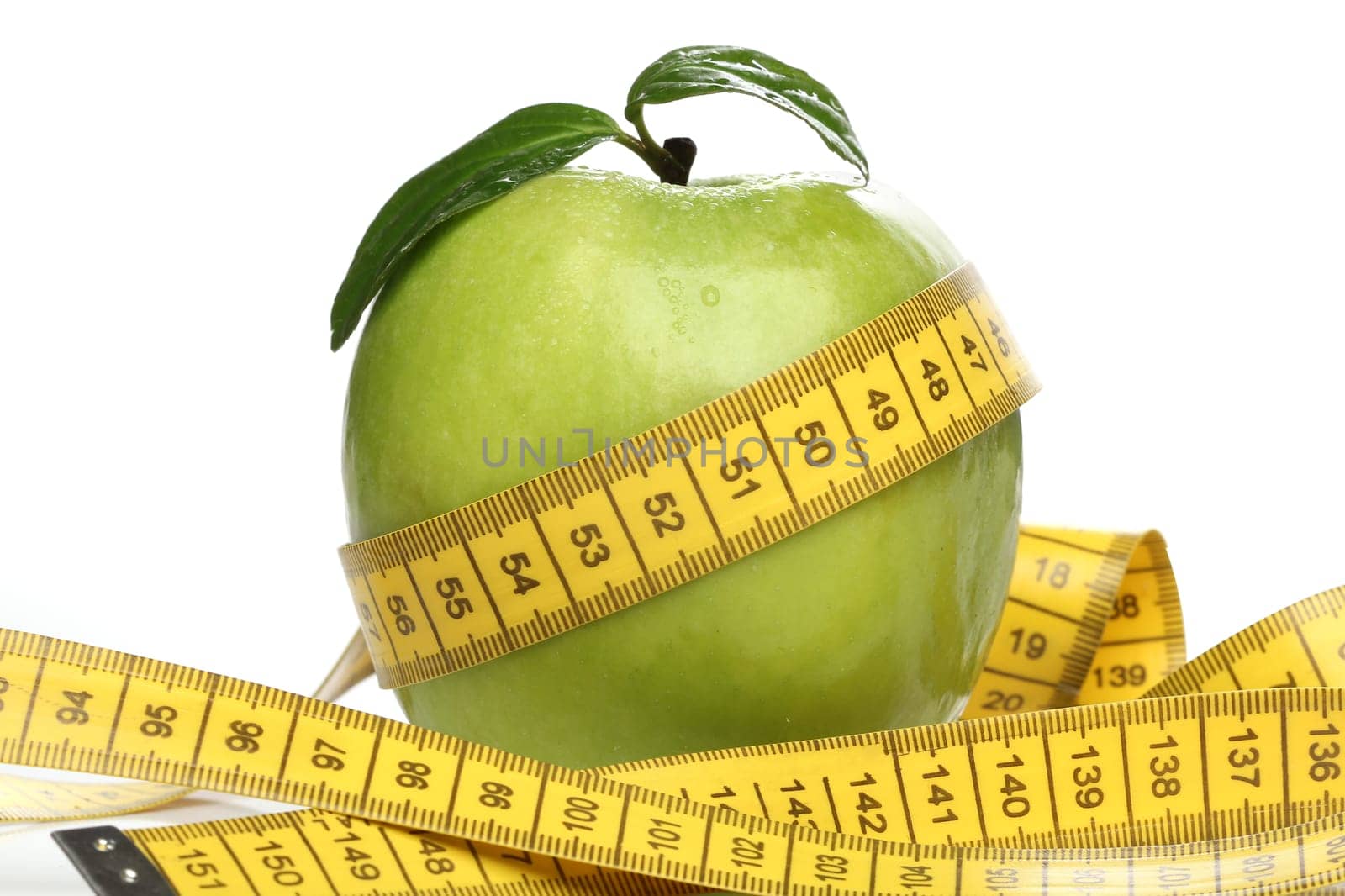 Healthy green apple and a measuring tape isolated