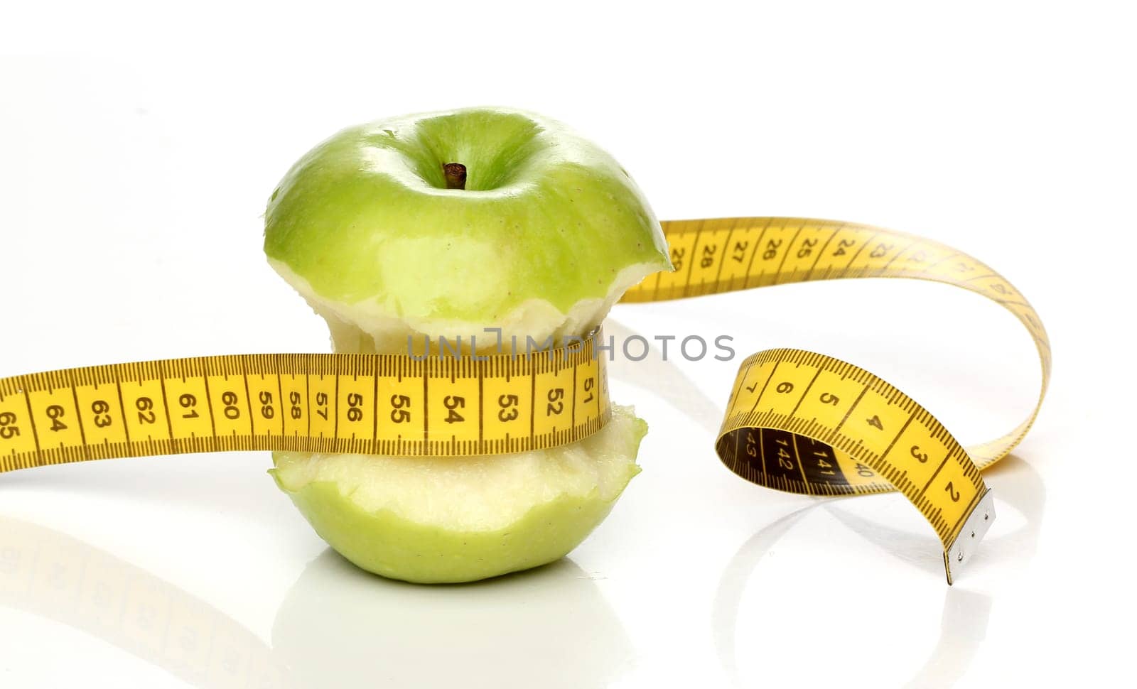Eaten green apple and a measuring tape isolated