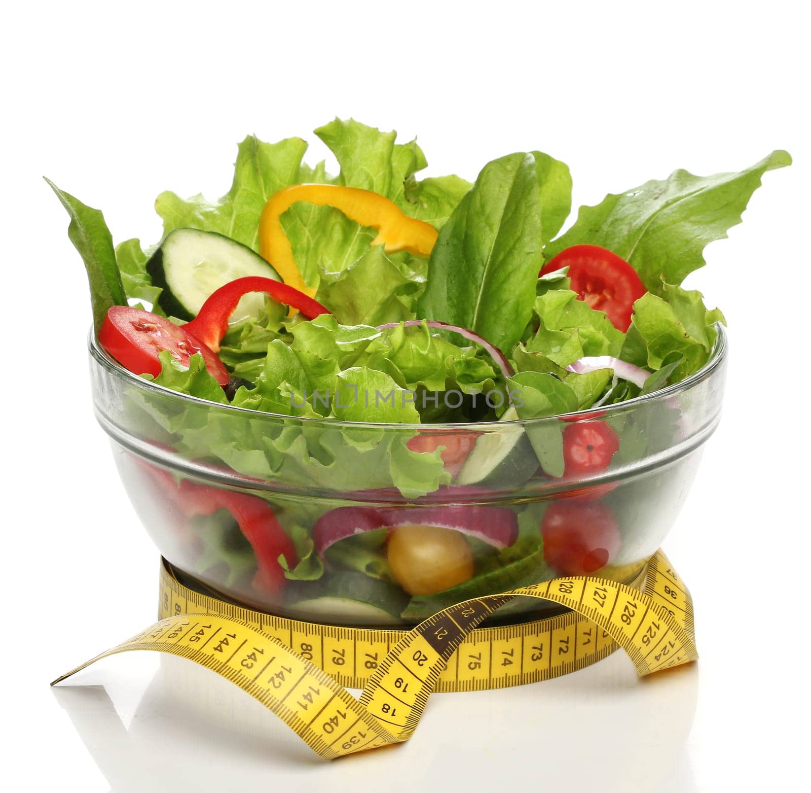 Healthy salad and a measuring tape isolated