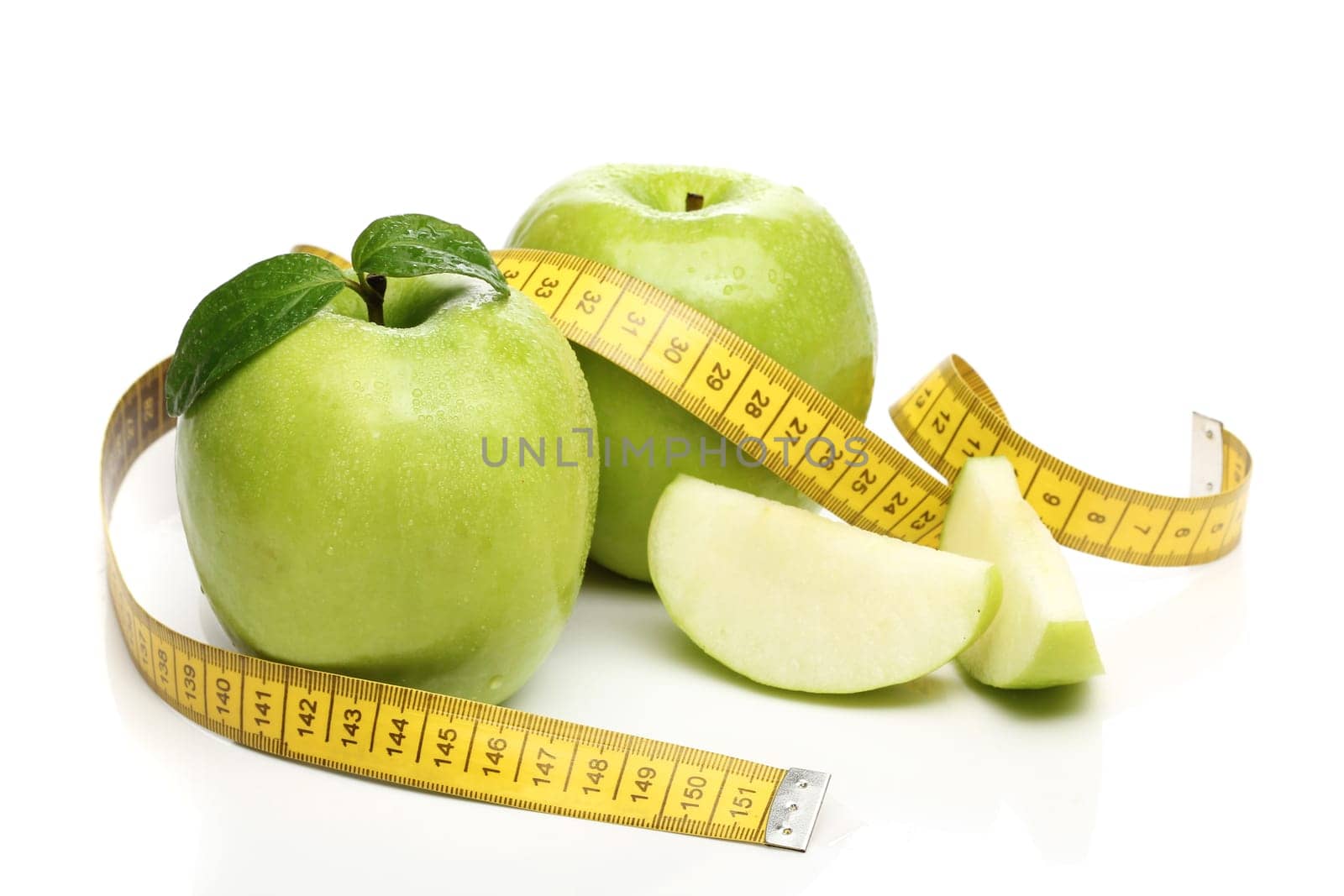 Healthy green apple and a measuring tape isolated