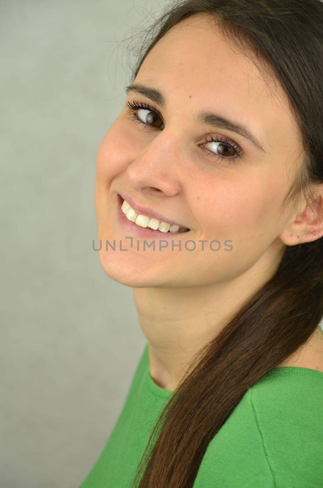 Portrait of a beautiful long-haired girl on blue background