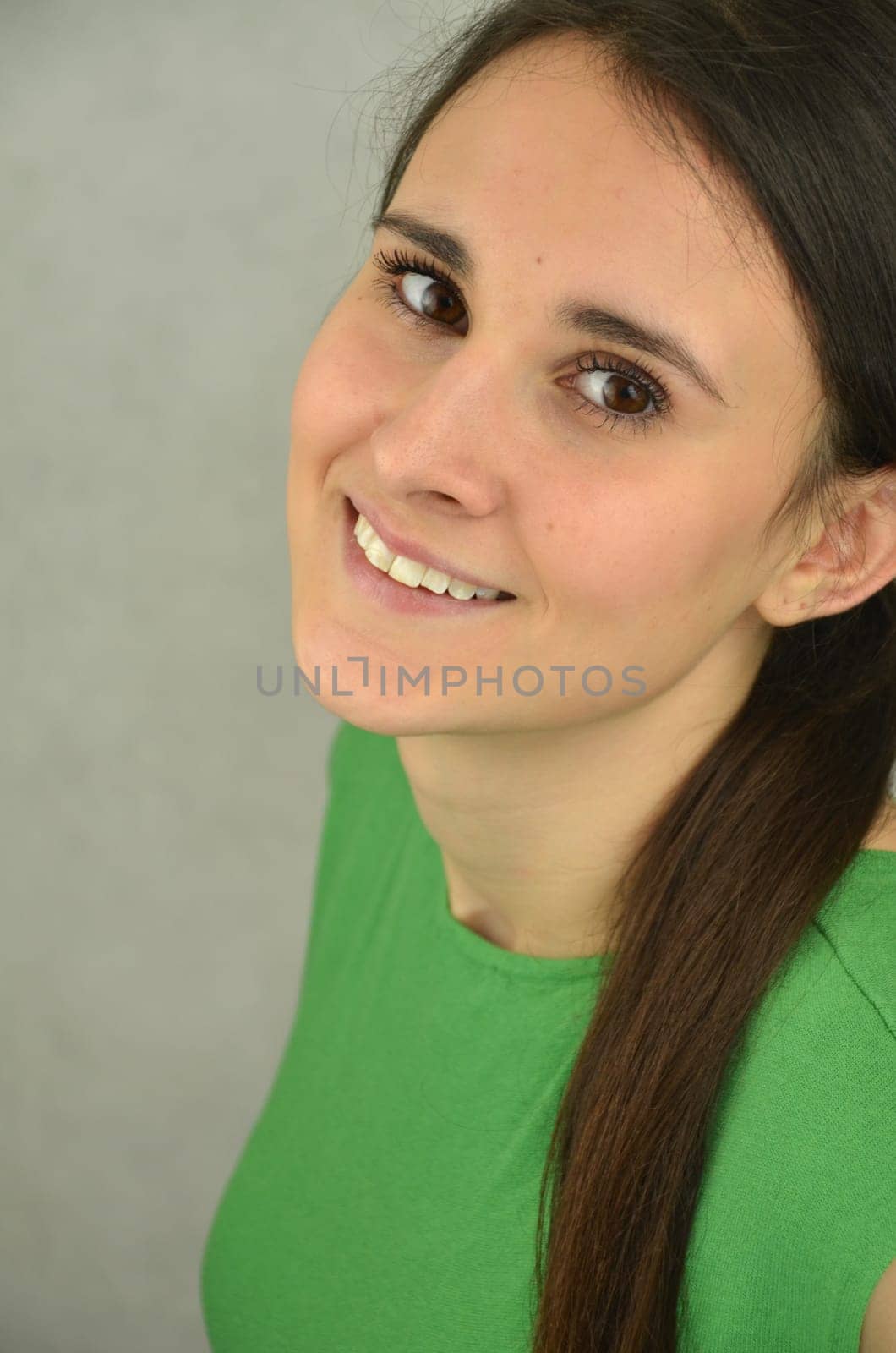 Portrait of a beautiful long-haired girl on blue background