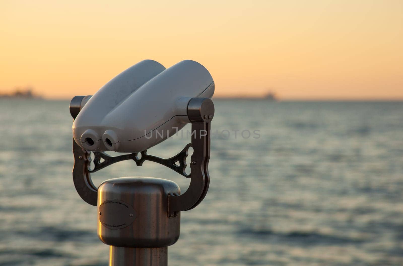 Photo of a tourist binoculars next to the sea in Trieste