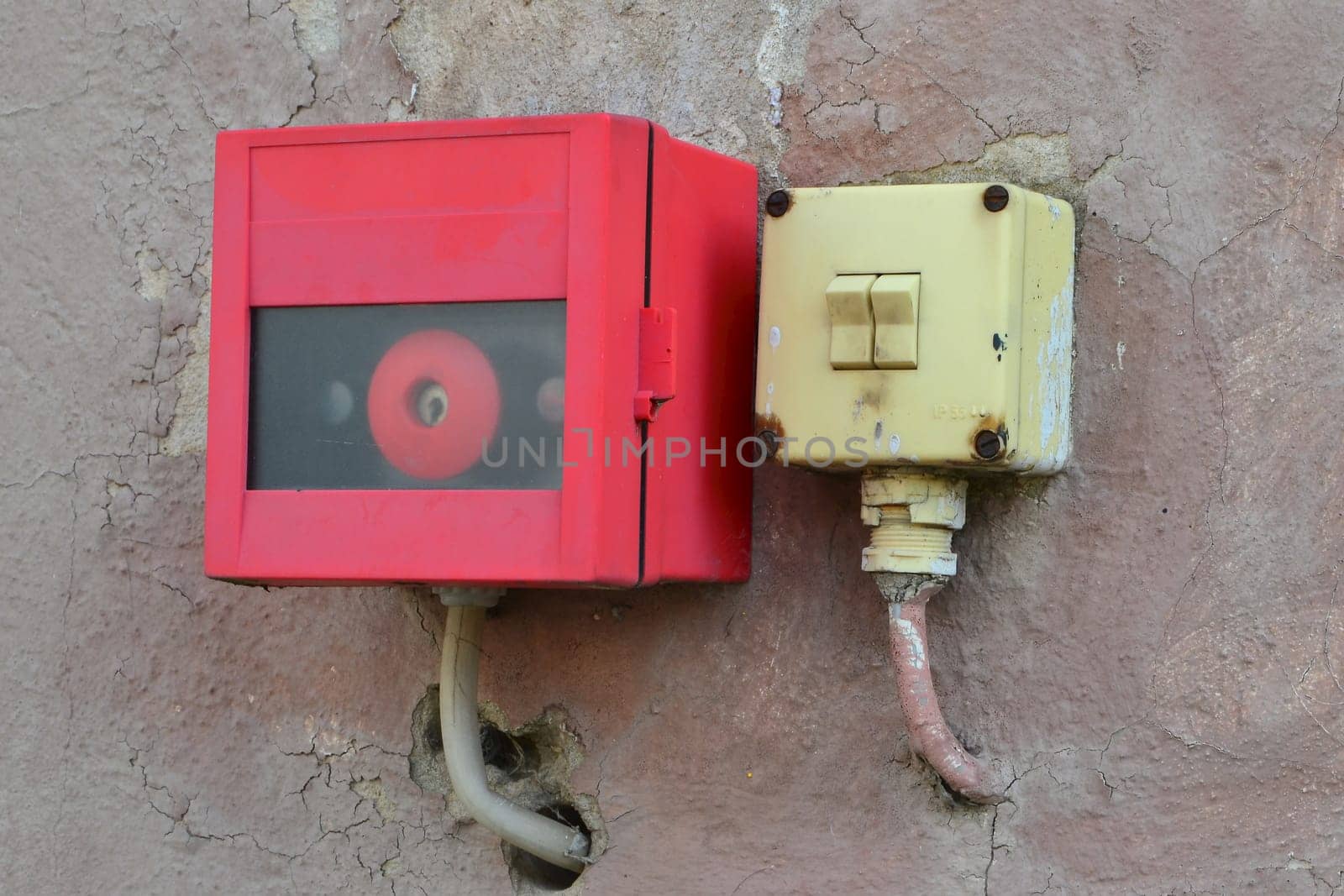 Light switch and alarm button on a façade