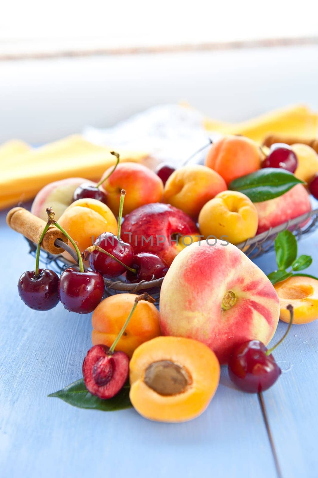 Different types of peaches,cherries and apricots in a wire body