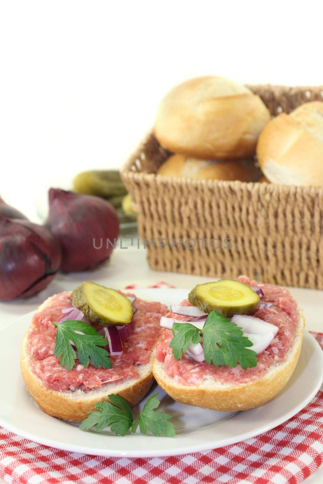 a Mettbrötchen with onion and cucumber