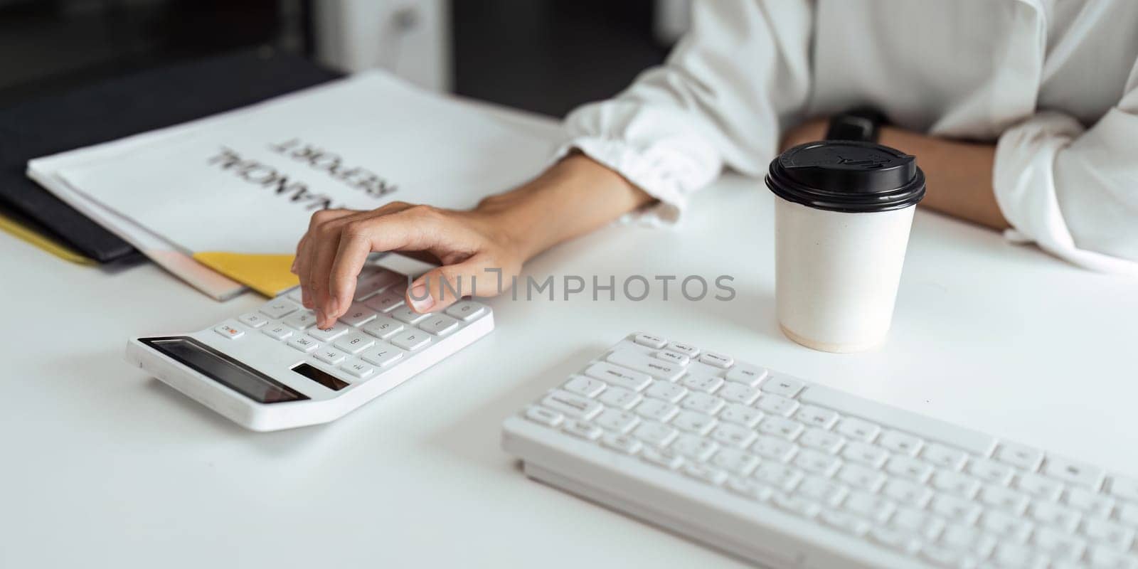 businesswoman accountant using calculator for checking financial data saving in office room.
