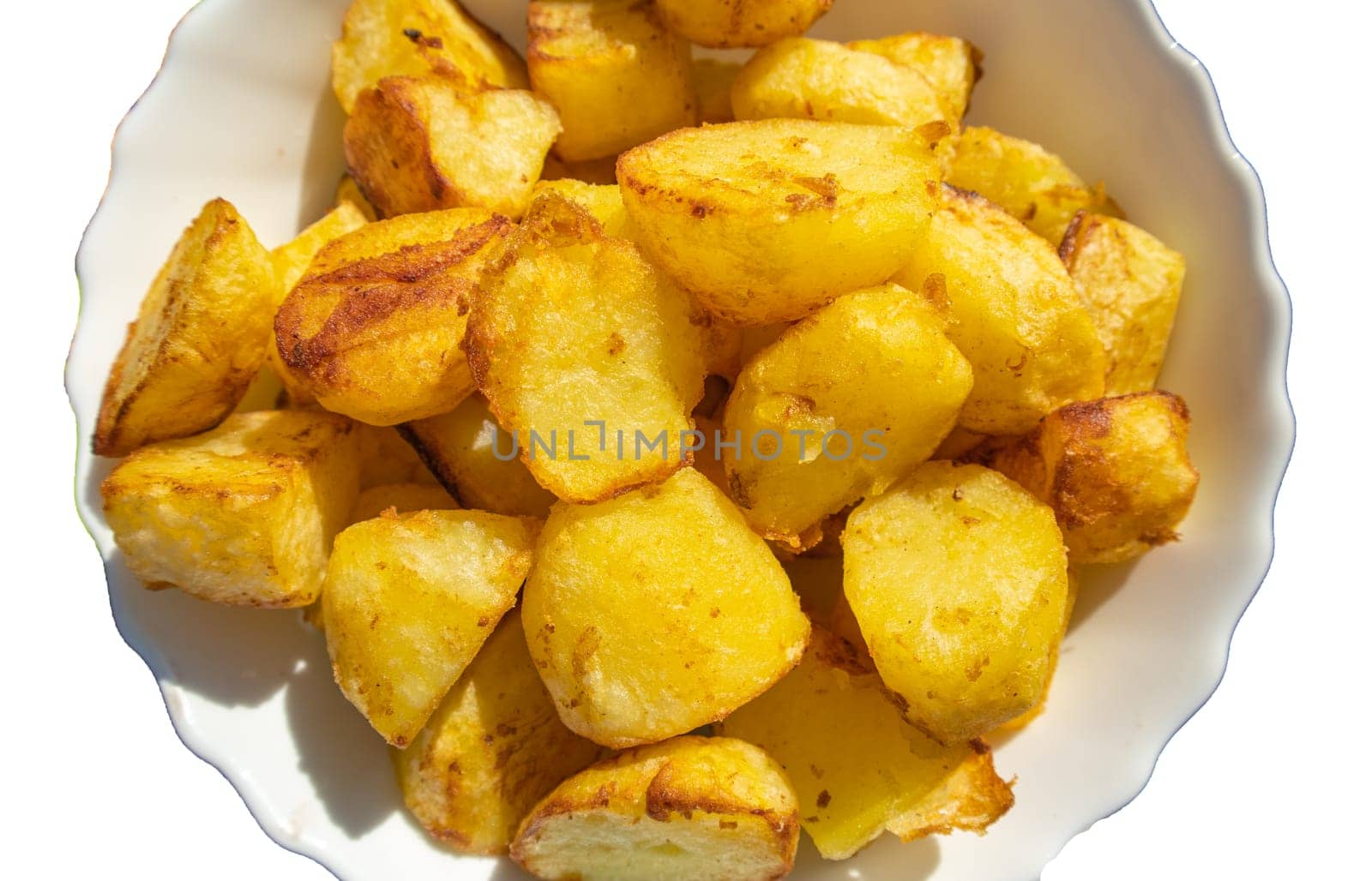 A pile of fried potatoes, cut into large slices, cut out and isolated on a white background by claire_lucia