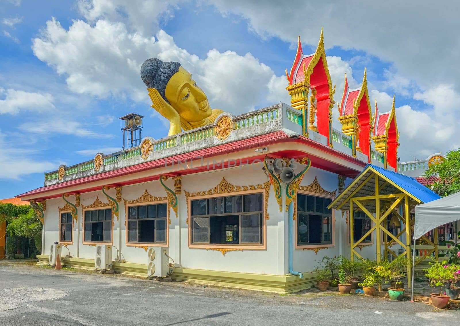 Big lying golden Buddha statue at Wat Sri Sunthon temple by day, Phuket, Thailand