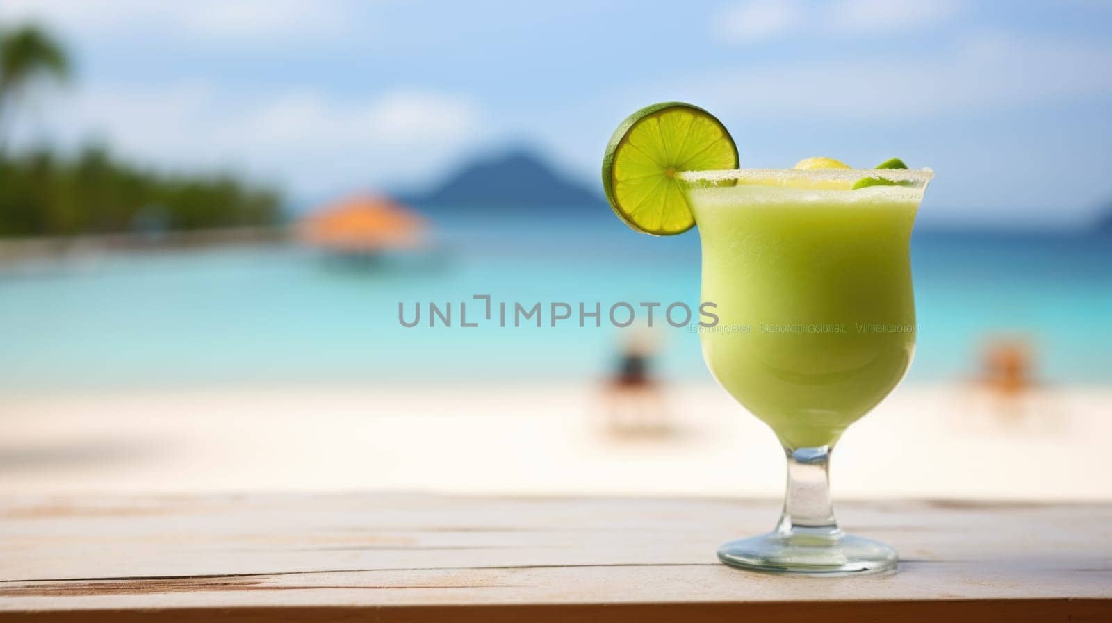 A green drink with lime on the beach