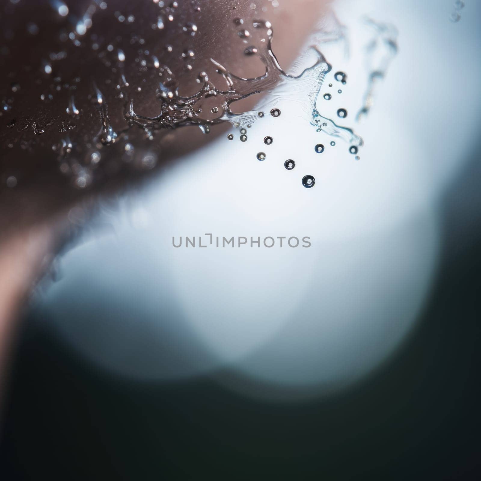 A close up of a man's face with water droplets