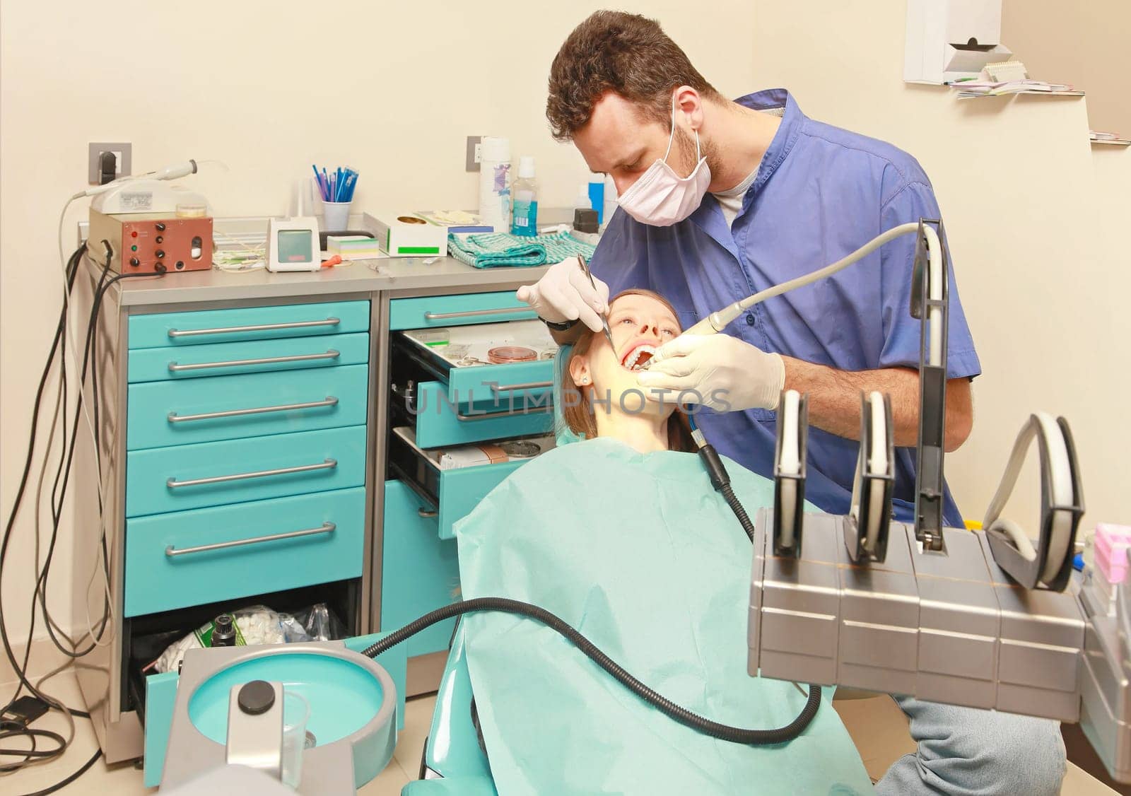 Dentist doctor drilling tooth in dental clinic