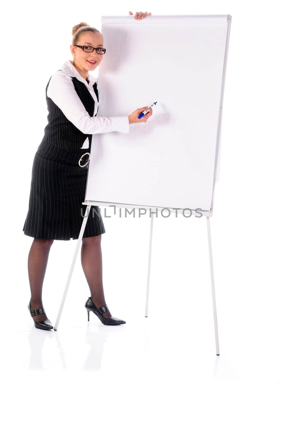 Young woman with blond hair in a business suit (tax consultant,manager,secretary) stands at the flipchart in front of a white background