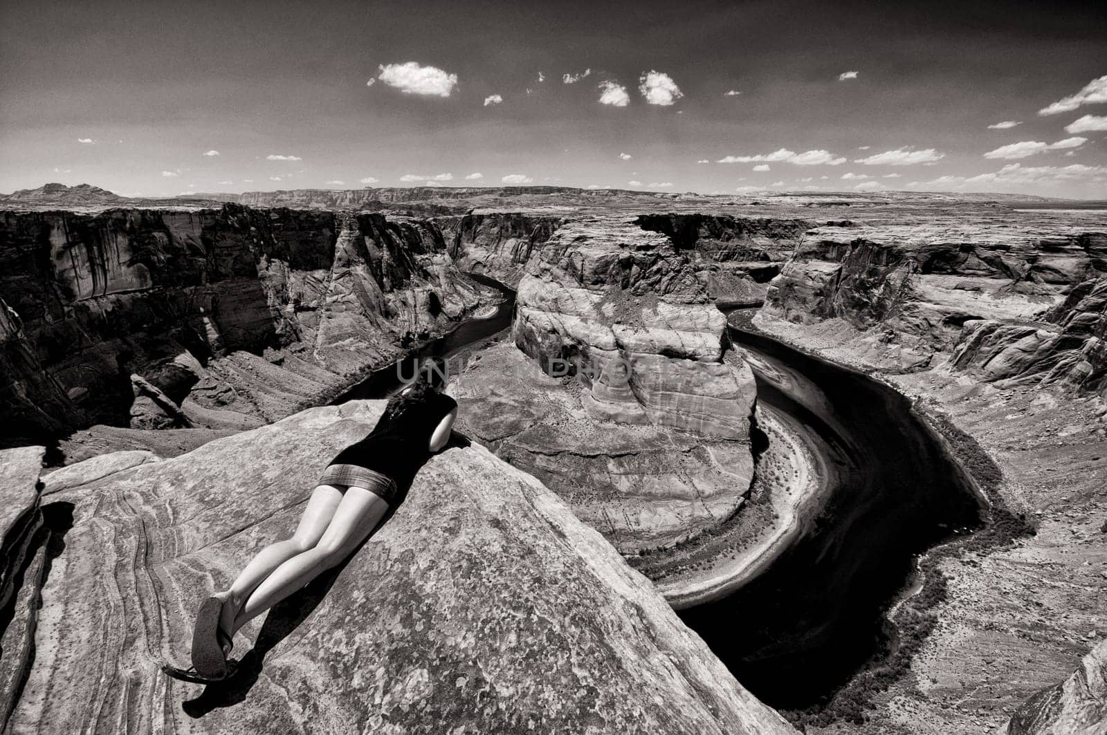 Woman looks over the edge of the abyss at the Grand Canyon,Arizona,USA