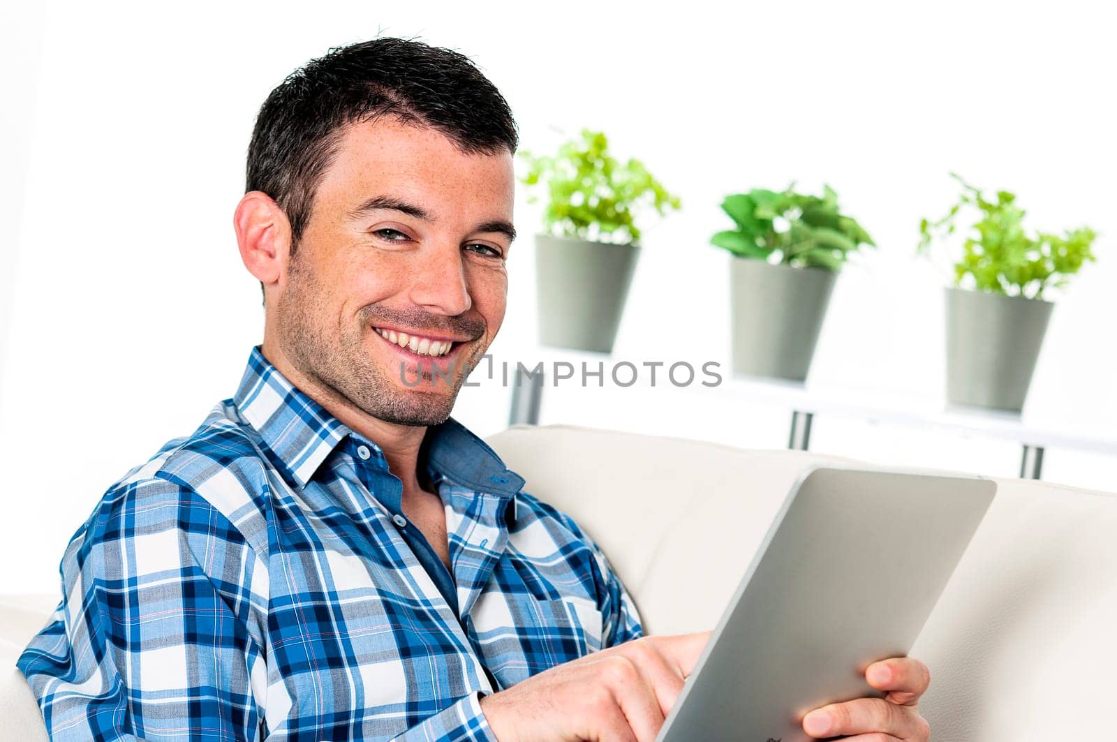 attractive relaxed and positive man is surfing on his