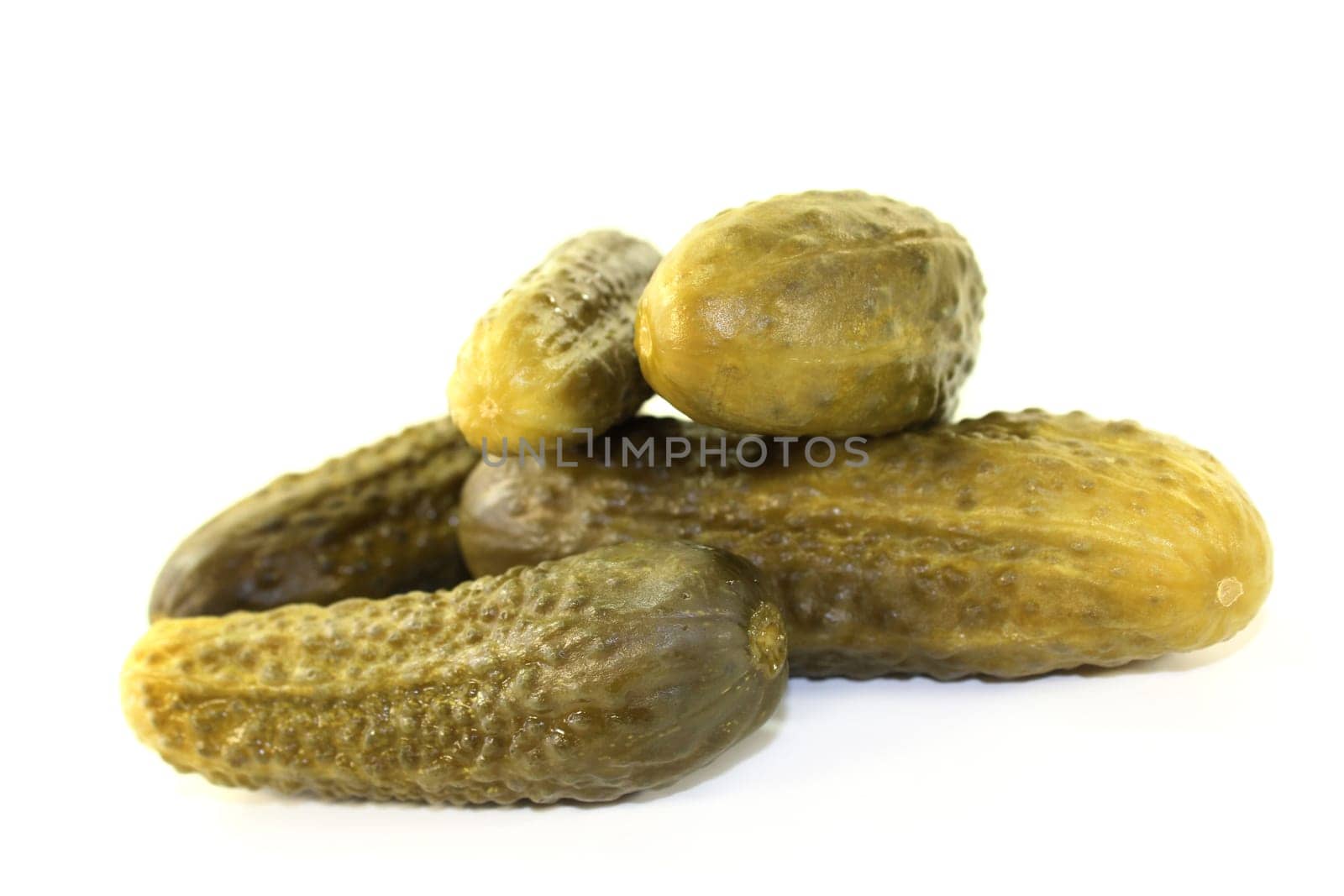 fresh pickles against a white background