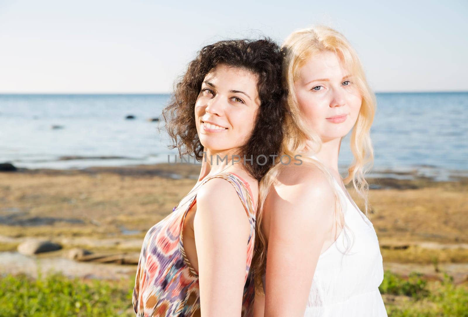 Two young womans at beach on calm silhouette