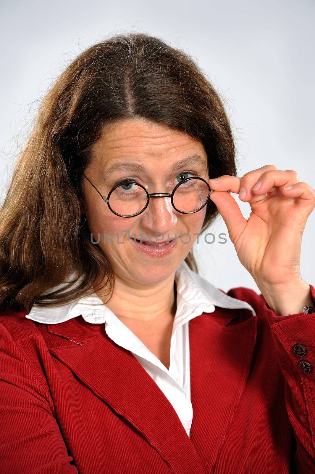 woman is looking over her glasses