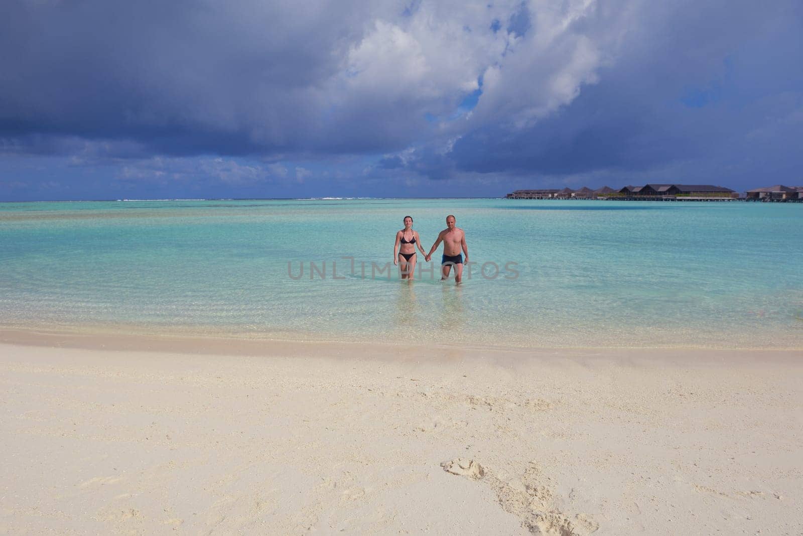 happy young  couple at summer vacation have fun and relax at beautiful sunny  day on beach