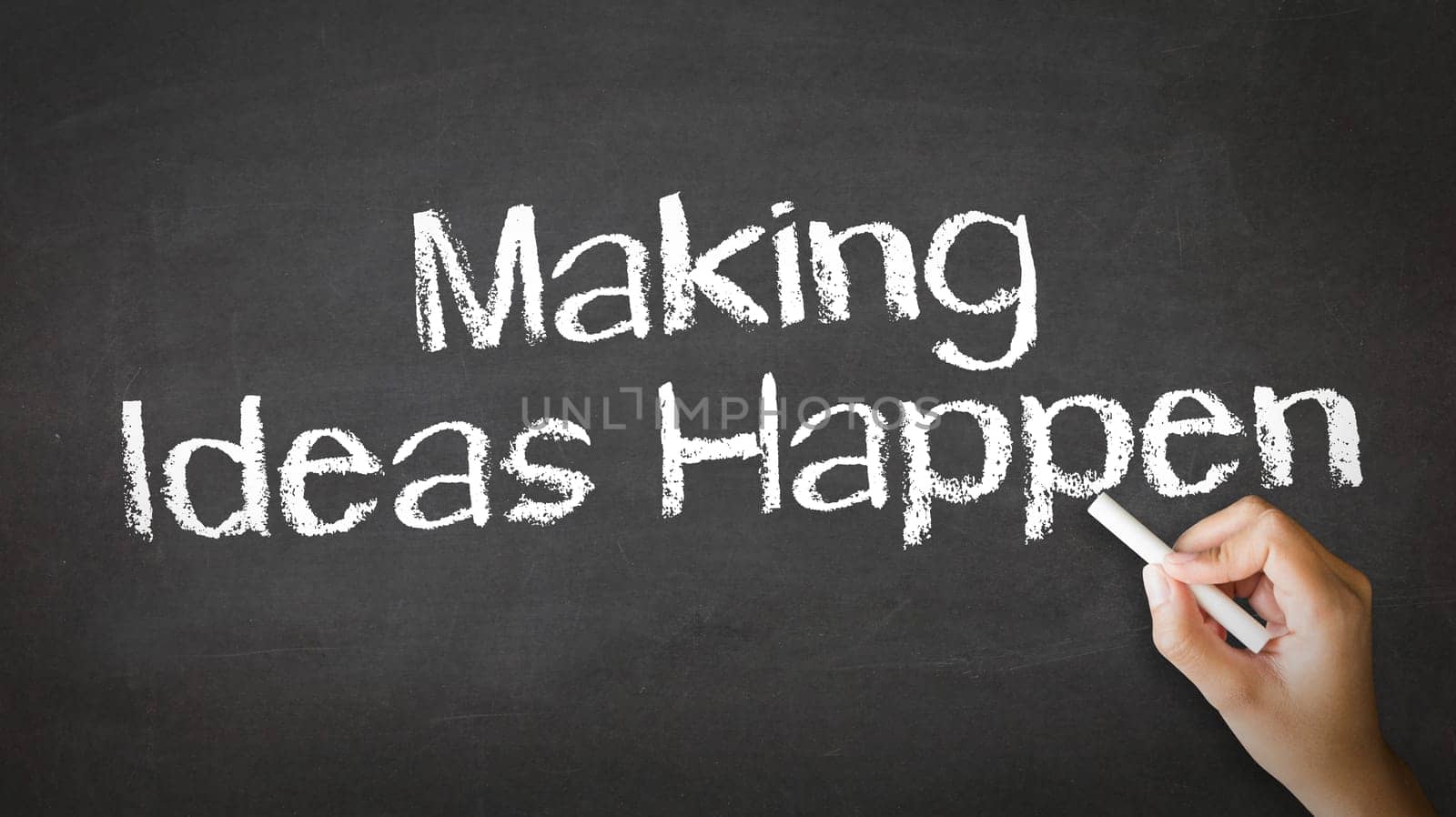 A person drawing and pointing at a Making Ideas Happen Chalk Illustration