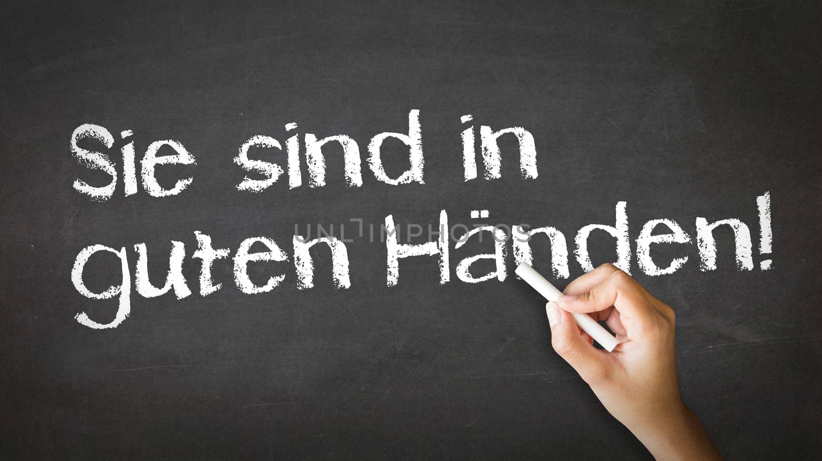 A person drawing and pointing at a Your Are in Good Hands Chalk Illustration