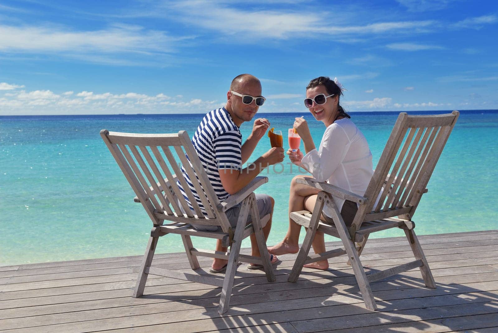 happy young couple relax and take fresh drink at summer vacation