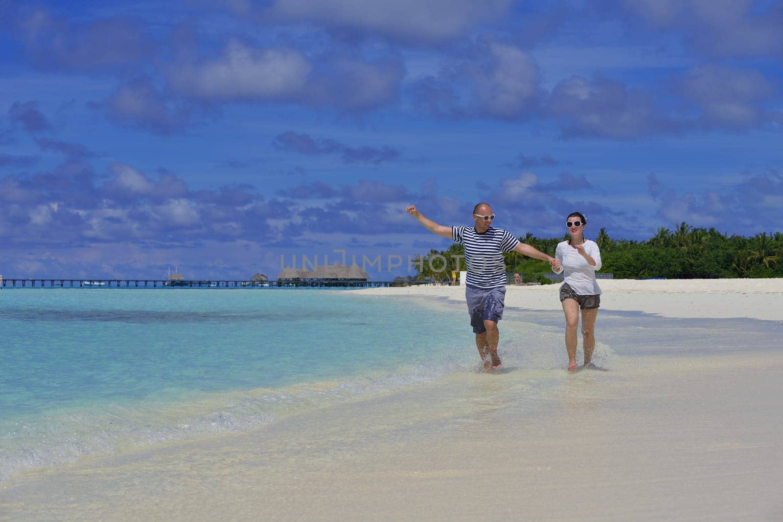 happy young  couple at summer vacation have fun and relax at beautiful sunny  day on beach