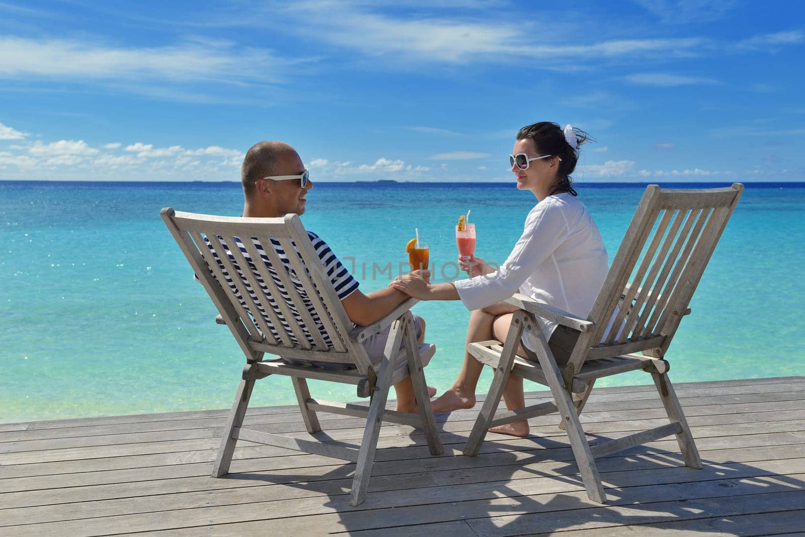 happy young couple relax and take fresh drink at summer vacation
