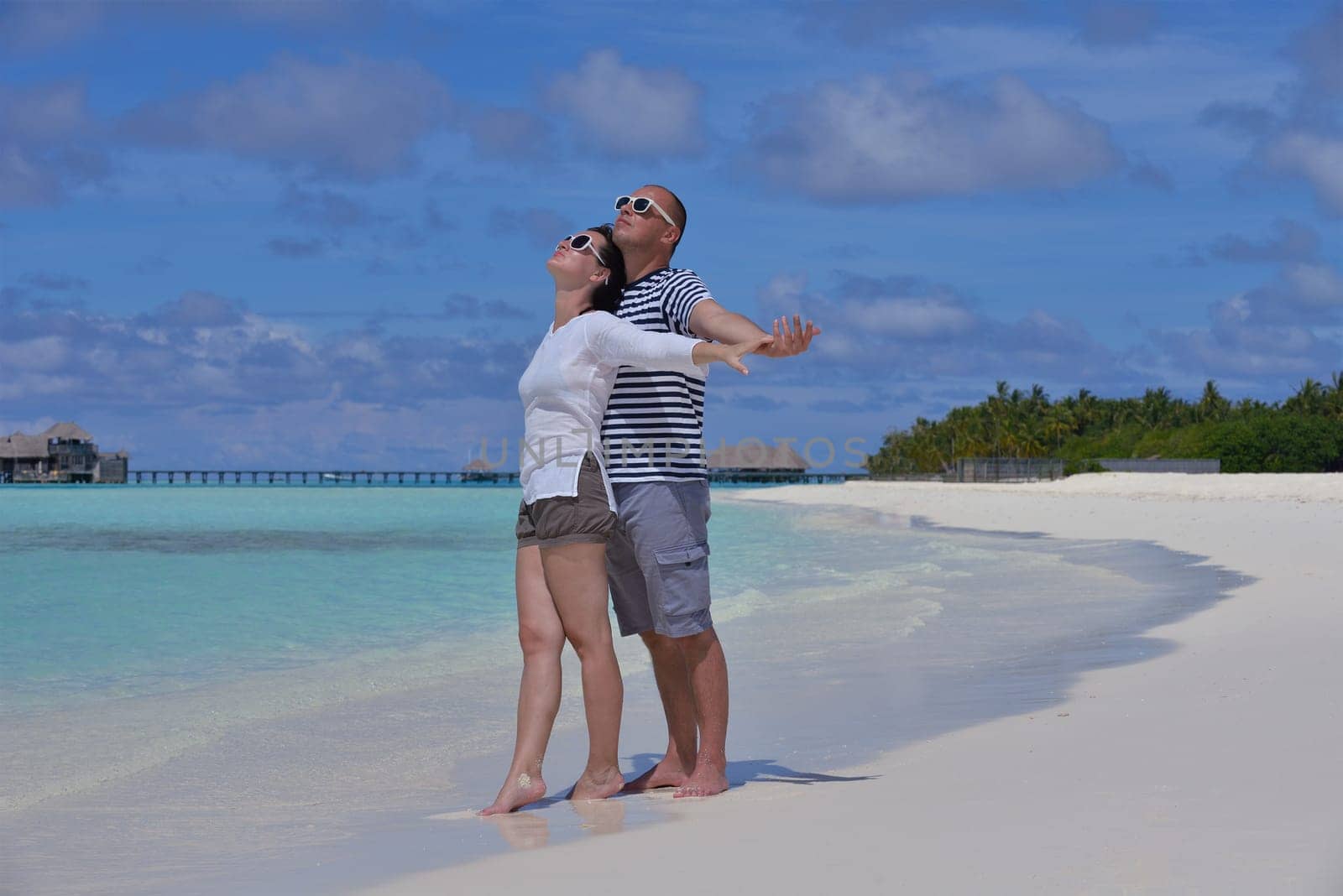 happy young  couple at summer vacation have fun and relax at beautiful sunny  day on beach