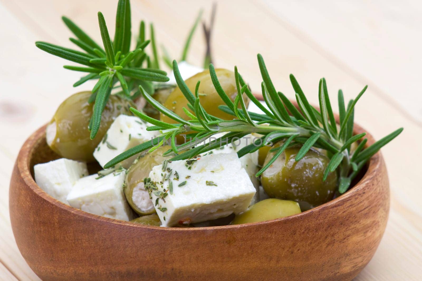 feta cheese and olives with herbs in olive oil