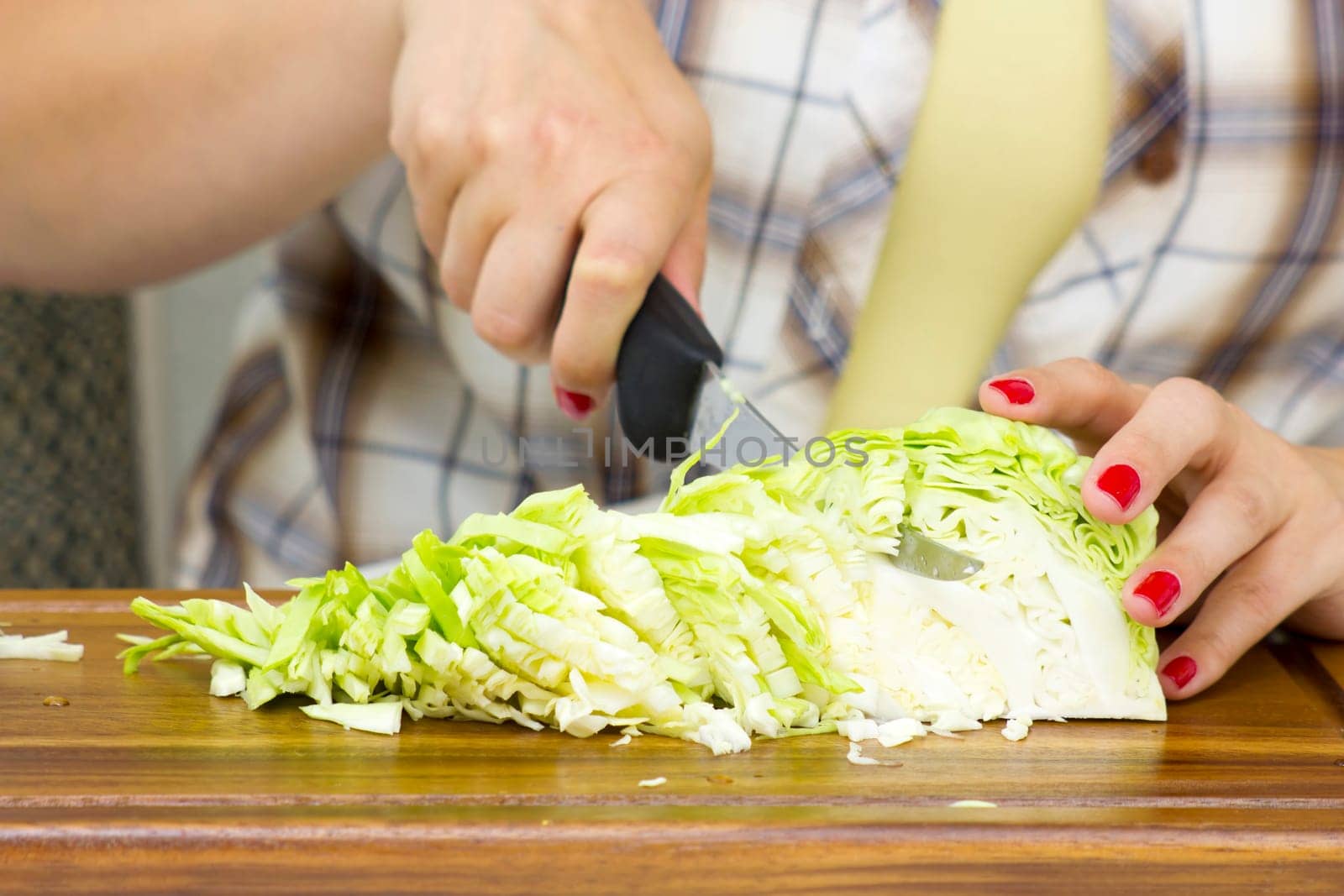 woman cutting cabbage