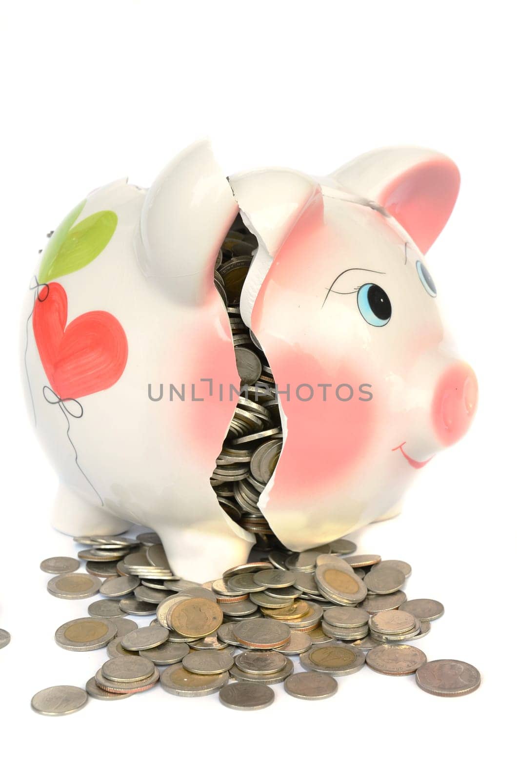 Pink piggy bank broken with money isolated on white background