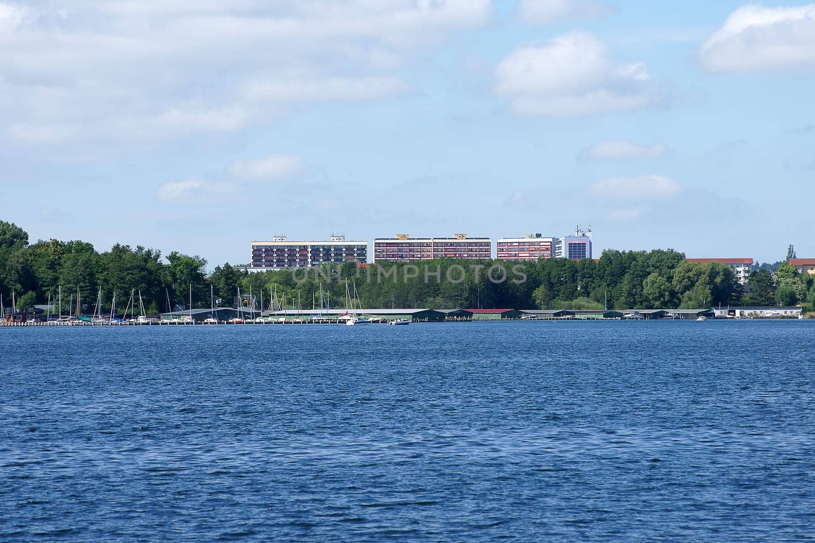 The photograph of a harbour and skyscrapers on Lake Mueritz.