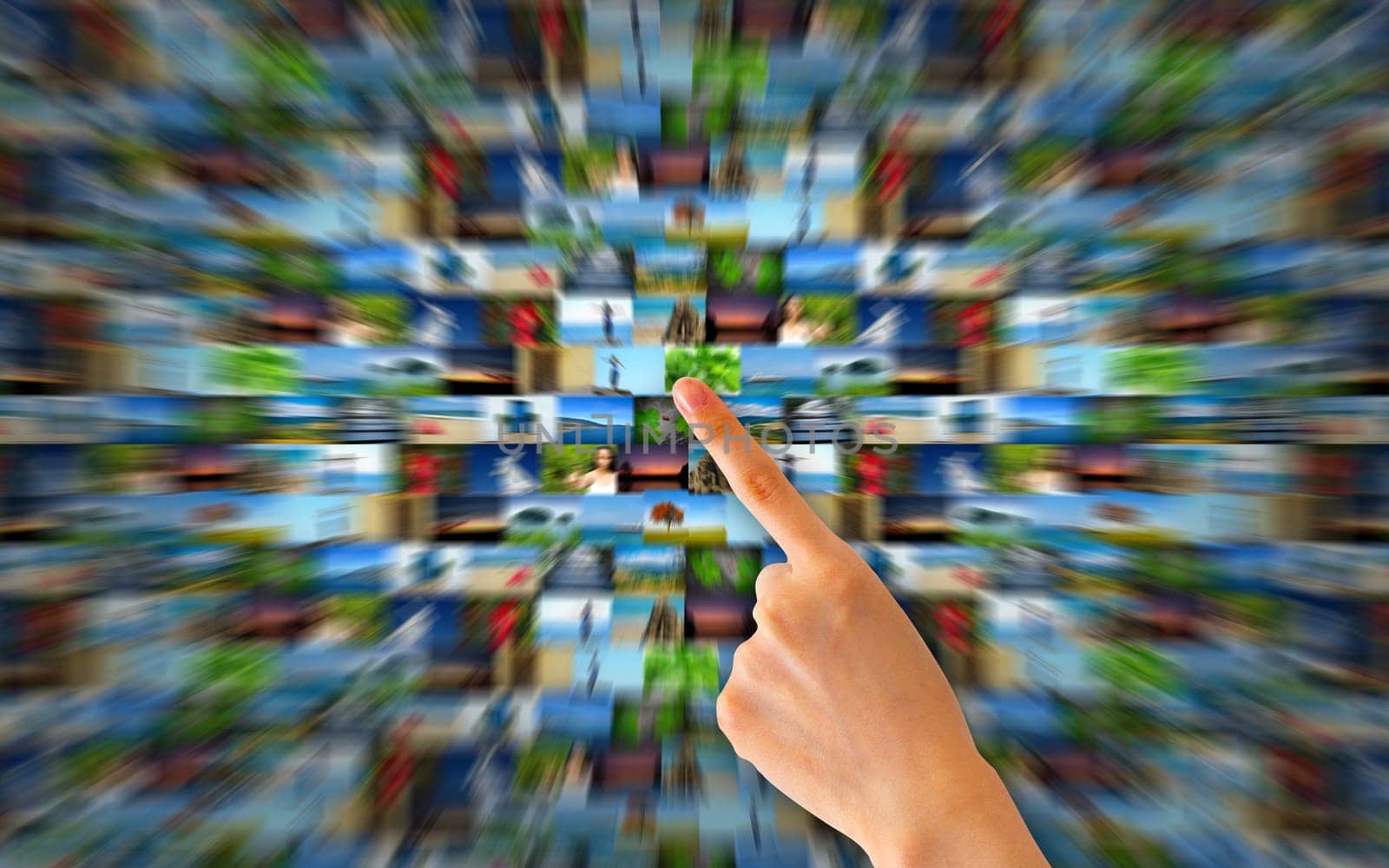 Hand pointing at many motion blurred photos.