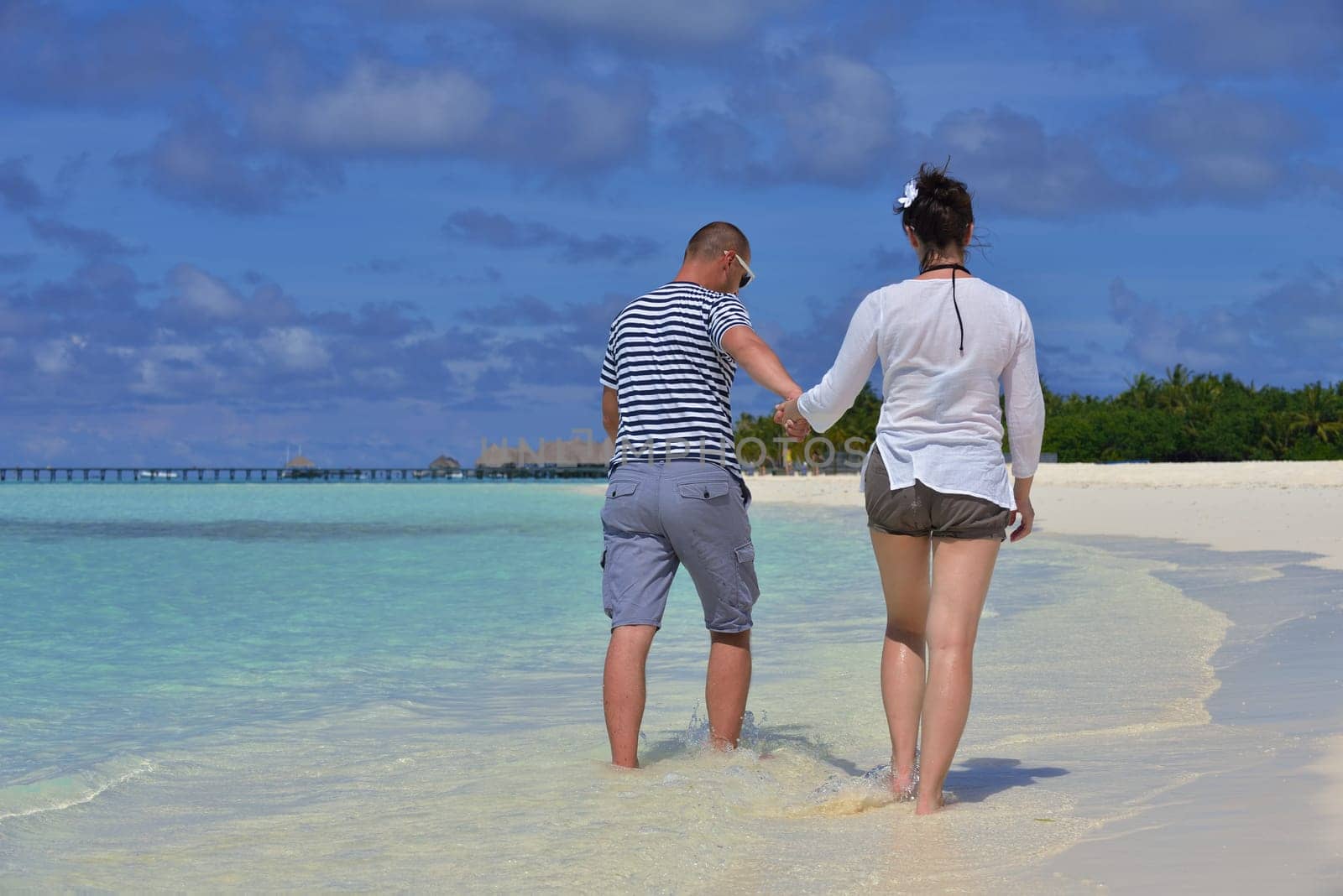 happy young  couple at summer vacation have fun and relax at beautiful sunny  day on beach
