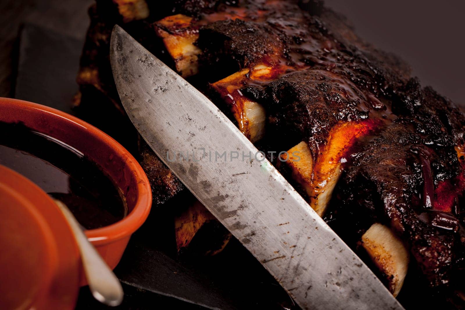 Beef ribs cooked on the BBQ and served with sweetcorn and a red wine souse.