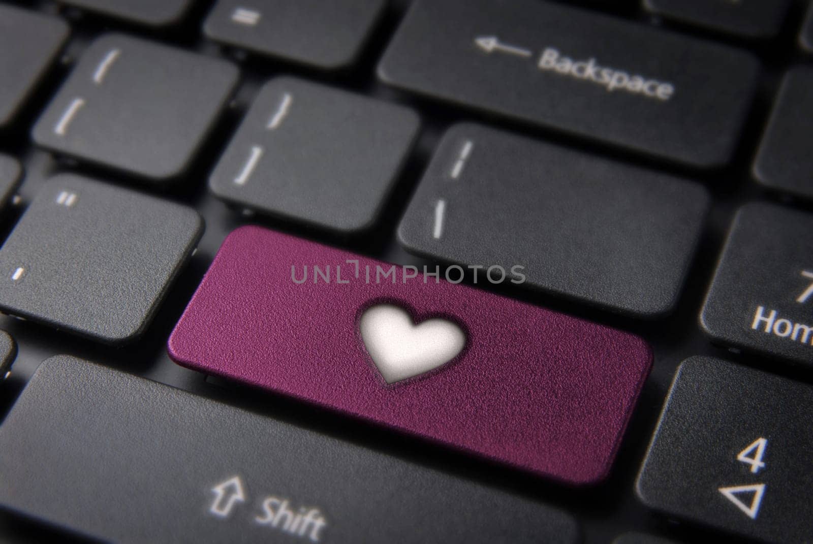 Online Love concept key with heart icon on laptop keyboard. Included clipping path, so you can easily edit it.