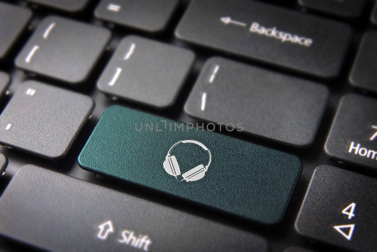 Entertainment key with headphones icon on laptop keyboard. Included clipping path, so you can easily edit it.