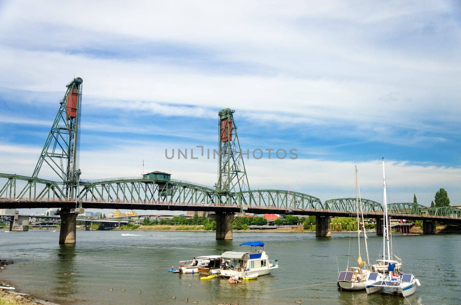 Hawthorne Bridge in Portland, Oregon and view of the Willamette River with several boats in the foreground