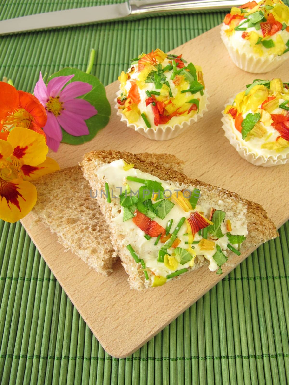 Herb butter chocolates with edible flowers on bread