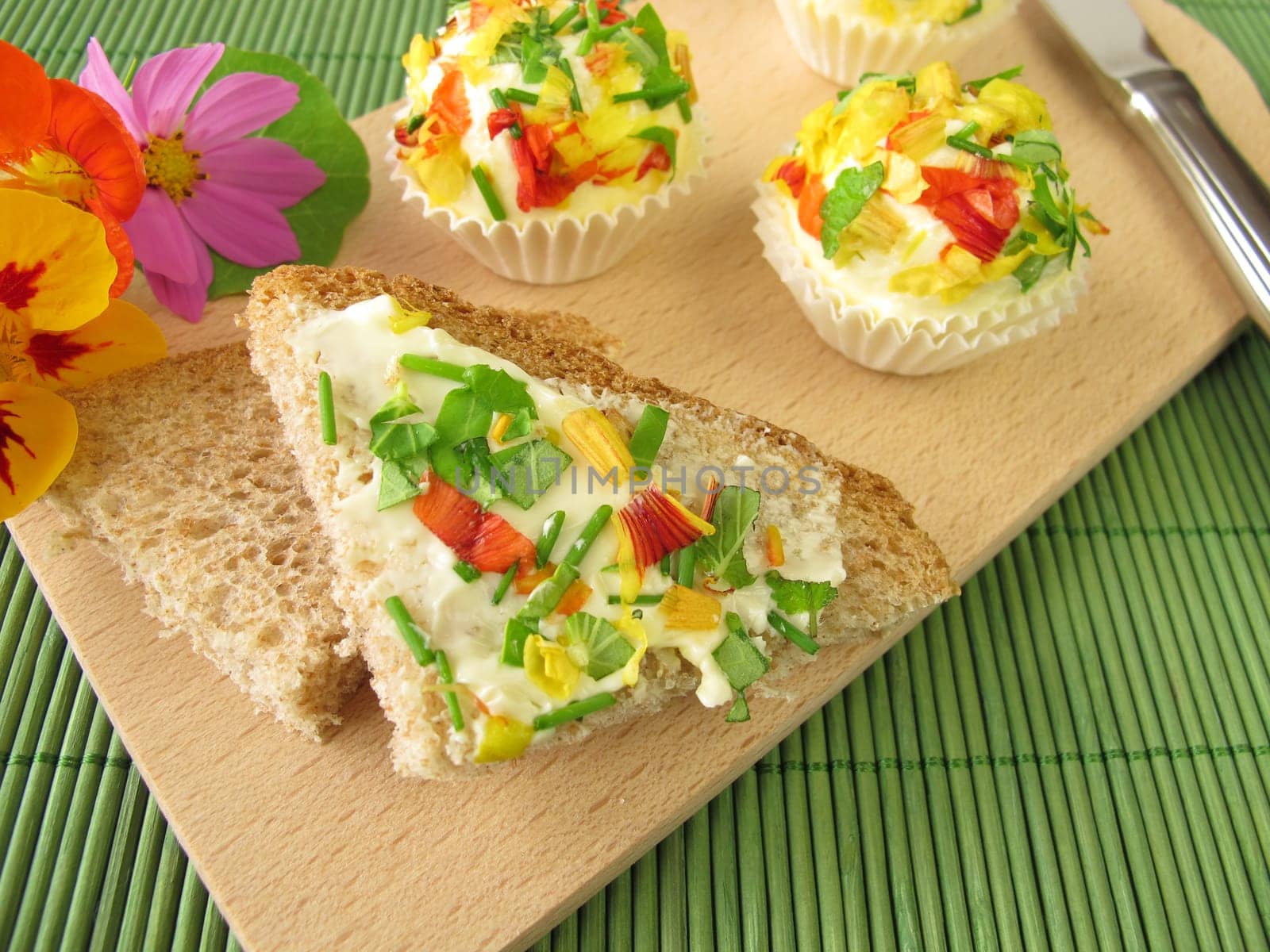 Herb butter chocolates with edible flowers on bread