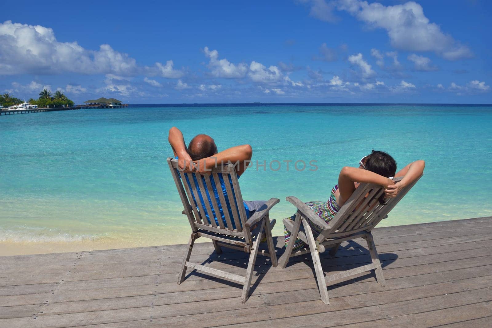 happy young couple have fun and relax at summer vacation on background maldives travel location and beautiful white sand beach