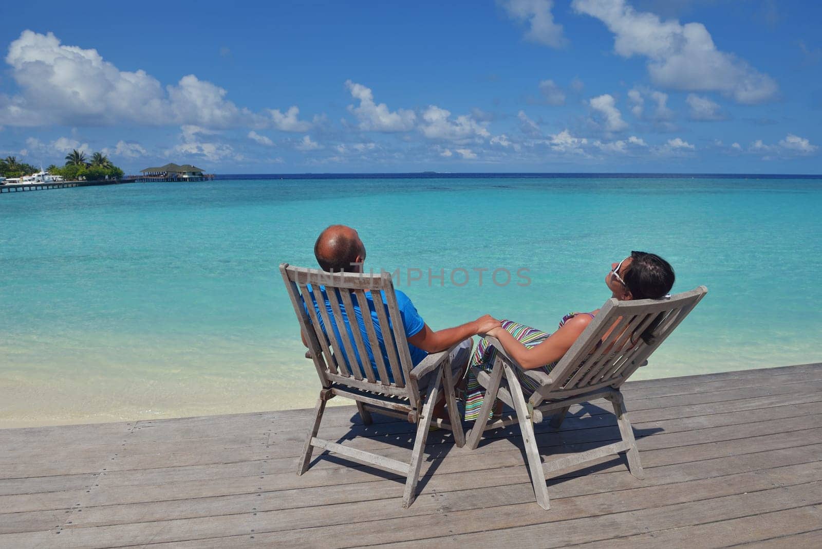 happy young couple have fun and relax at summer vacation on background maldives travel location and beautiful white sand beach