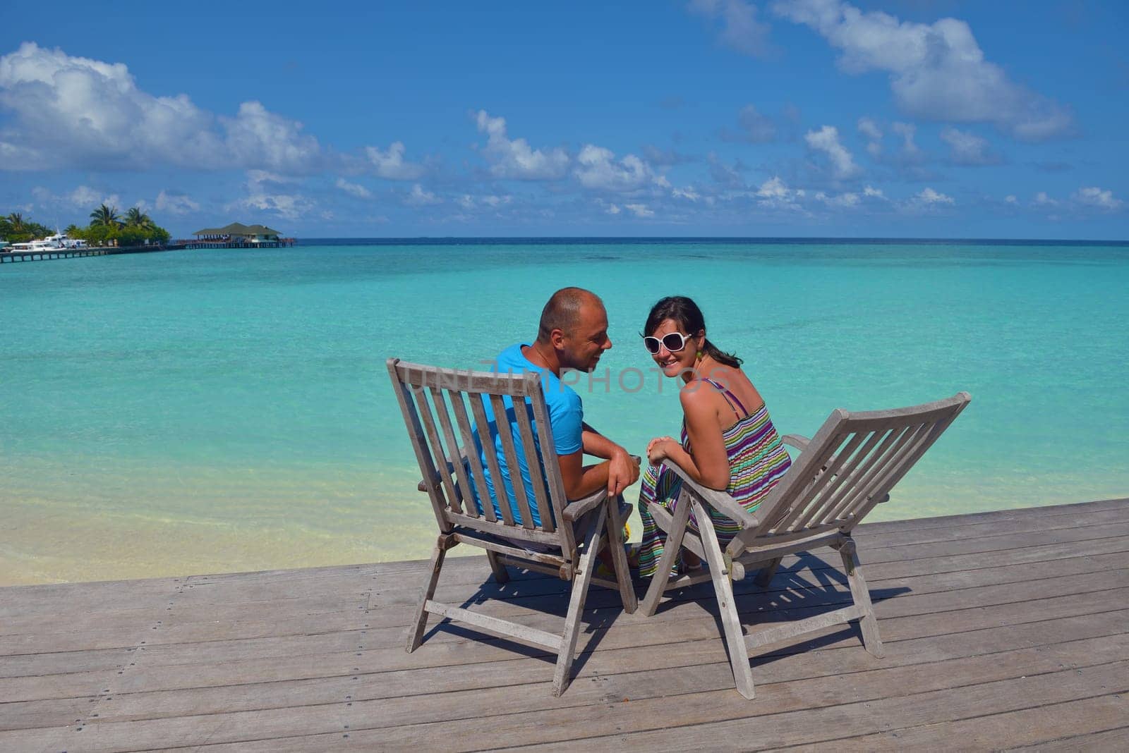 happy young couple have fun and relax at summer vacation on background maldives travel location and beautiful white sand beach